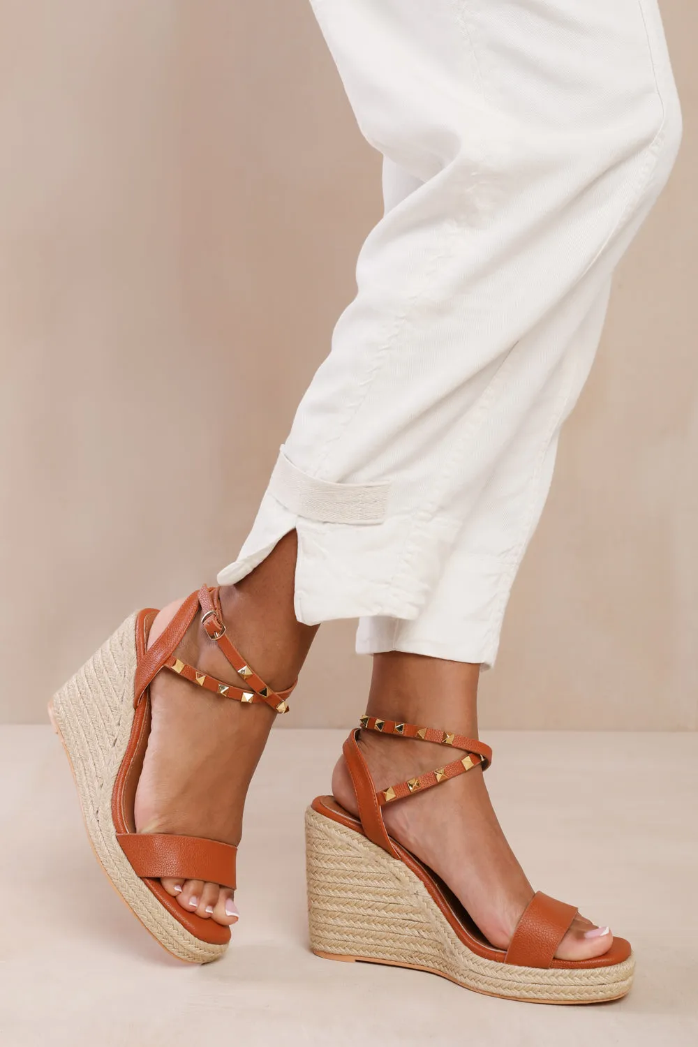 TEXAS CROSS OVER ANKLE STRAP WITH STUDD DETAIL ESPADRILLE WEDGES IN TAN FAUX LEATHER